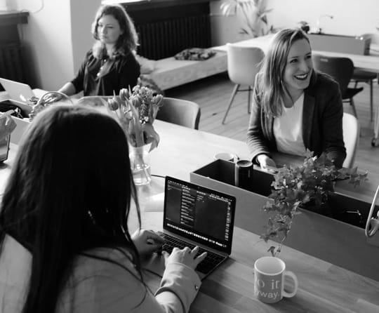 3 women are in conference room and doing meeting with presentations